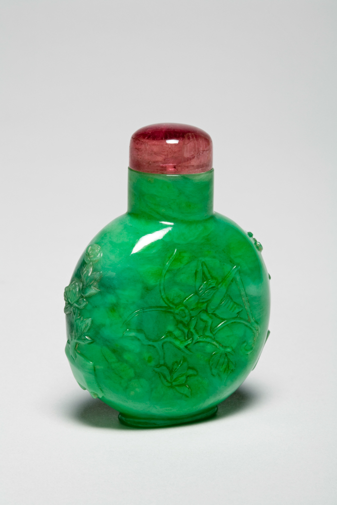 An image of Snuff bottle. Decorated with a continuous scene of birds amid peony blossoms and perched in a gnarled tree. Glass with famille rose enamels in red, orange, and yellow tones imitating realgar, height 6.2 cm, 1730-1850. Chinese. Qing Dynasty (1644-1912).
