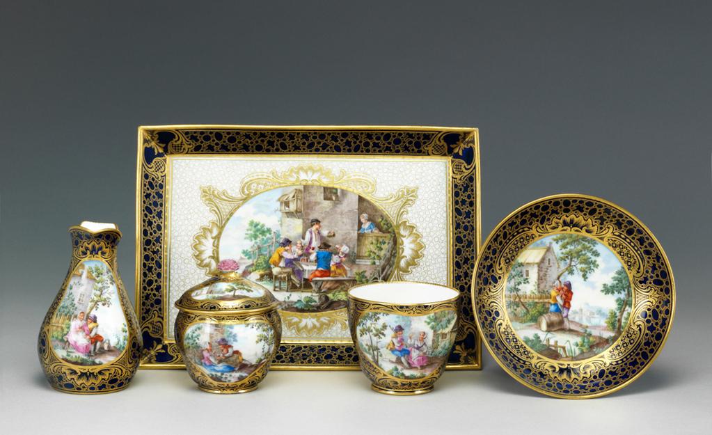 An image of Broc ordinaire. Part of a dejeuner comprising a tray, cup and saucer, and sugar basin and cover. Sèvres Porcelain Manufactory. Vielliard, André-Vincent (French, 1717-90, act.1752-1790). The reserve is painted in polychrome with a man and woman peasant sitting on a bench in front of a cottage with a landscape in the background. Soft-paste porcelain decorated with an underglaze blue lapis ground, painting overglaze in blue, and gilded, height 11.3cm, width 8.6cm, circa 1759. Rococo.