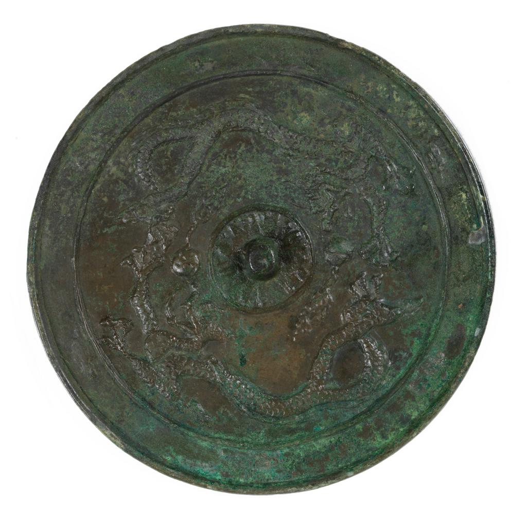 An image of Mirror. Unknown maker, China. Circular bronze mirror of slight convex curvature with two beaded dragons, three-clawed, scaly, chasing flaming pearls, the plain central knob surrounded by a zone of rays or lotus petals, the decorated side showing brown metal and some dare patination. Bronze, the mirror side bright green, 618-907. T’ang Dynasty (618-906).