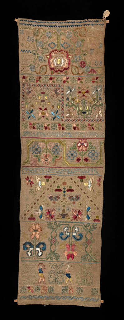 An image of Textiles. Band sampler. Unidentified maker, England. The sampler comprises 11 horizontal bands include repeat border patterns, an alphabet, 'boxers' and the initials 'EG EG SG IW'. Linen, embroidered with polychrome silks and silver metal threads in cross, double back, double running, satin and needle lace filling stitches. Length 68.9 cm, width 20.3 cm, circa 1675.