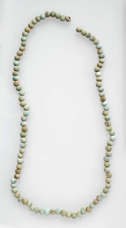An image of string of spherical beads, green glazed