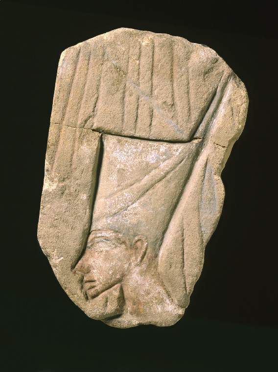 An image of Sandstone relief of AkhenatenA human head wearing a crown, rays of the Aten behind the figure, fragment. Interpreted as the ruler Akhenaten wearing the crown of Lower Egypt.