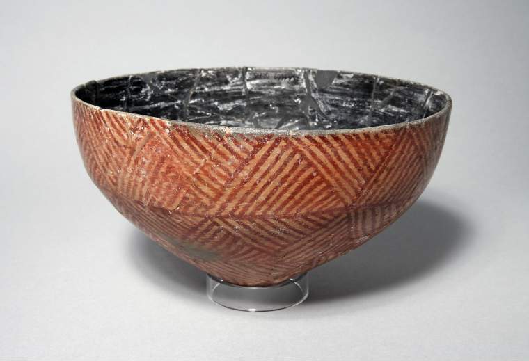 An image of Bowl, with decoration in red, in imitation of basket pattern