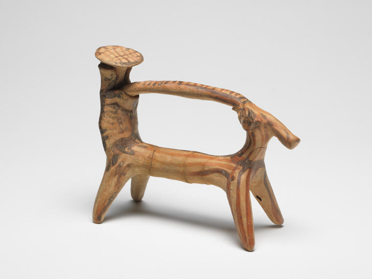 An image of man and woman in ox-cart. Hand-made. Dimensions height 0.09 m, length 0.12 m, width 0.05 m,