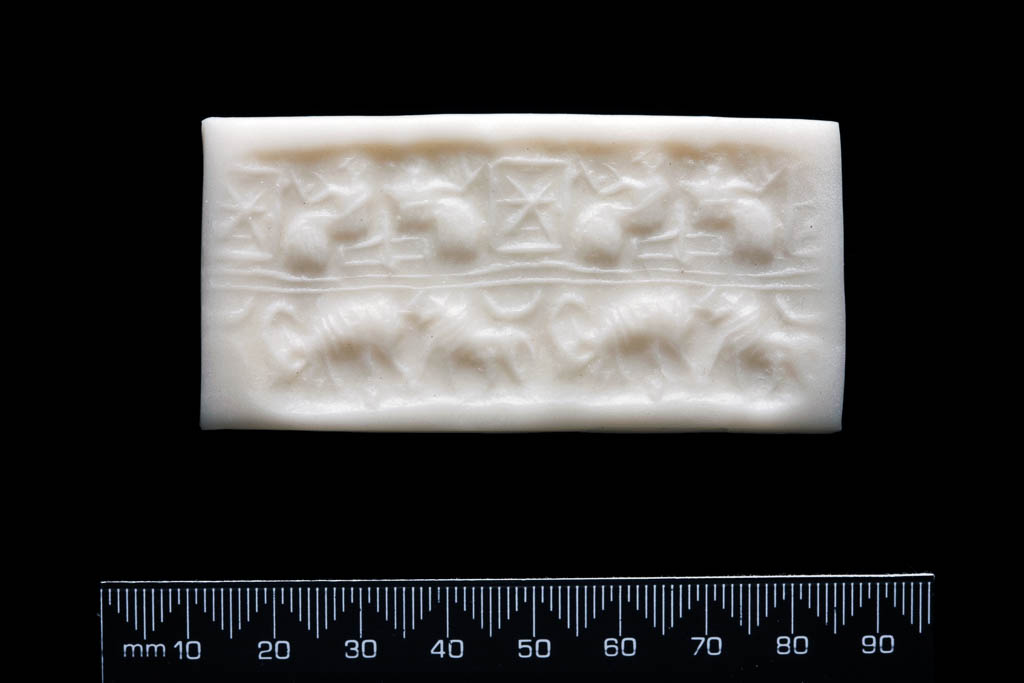 An image of Cylinder Seal. Grey-green serpentine or diorite, height 0.031 m, width 0.011 m, circa 2600 B.C. Early Dynastic III Period.