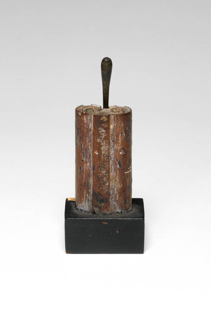 An image of Cosmetic equipment. kohl pot, with stick. Production Place: Egypt. Bronze stick, ebony inlay, ivory inlay, wood, length, 0.06 m, length, stick, 0.0875 m. New Kingdom.