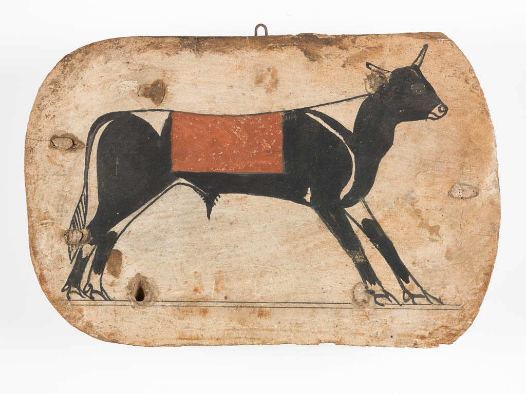 An image of Funerary Equipment/Coffin Element. Foot board from a cartonnage coffin. Apis bull, painted on board. Production Place: Egypt. Wood, height 21.2 cm, width 31.7 cm, thickness 1.8 cm, 745- 655 B.C. Period: 25th Dynasty-26th Dynasty.