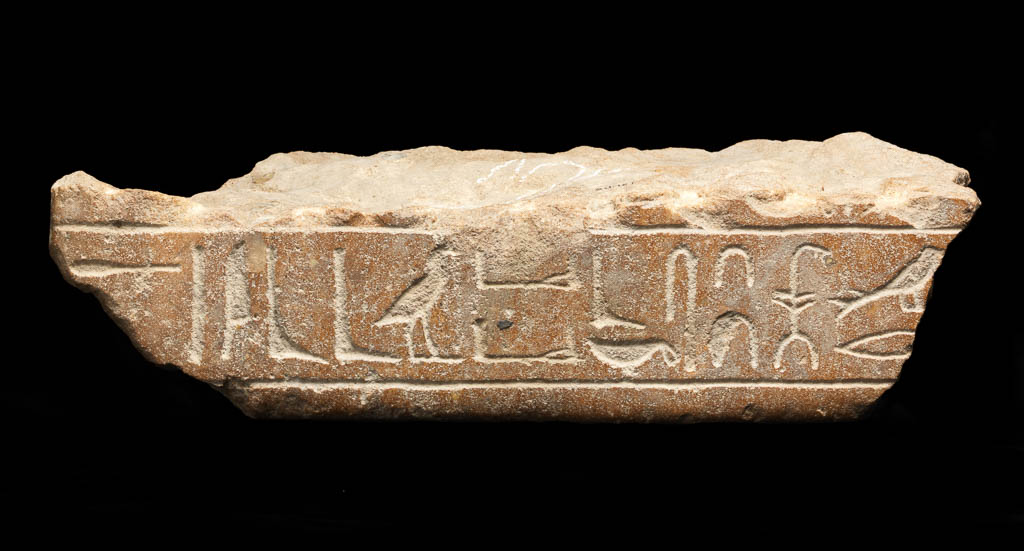 An image of Figure. Fragment from a statue with an inscription, in hieroglyphs. Production Place/Find Spot: Egypt. Depth 0.18 m, length 0.1 m, width 0.4 m. Thirteenth Dynasty. Middle Kingdom.