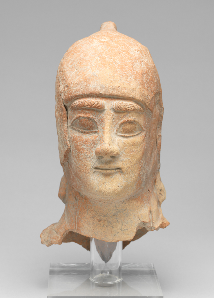 An image of Figure/Head. Male head, wearing cap. Production Place: Cyprus. Find Spot: Salamis, Cyprus. Clay, moulded, height 0.236 m, width 0.102 m, 600-501 B.C. Archaic Period.