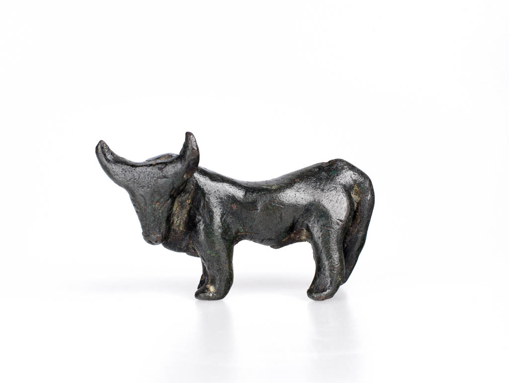 An image of Figurine of a bull, Greek. Copper alloy, height 0.05 m, length 0.087 m, 600-501 B.C. Field Collection: Cesme, Ionia, Turkey. East Greece.