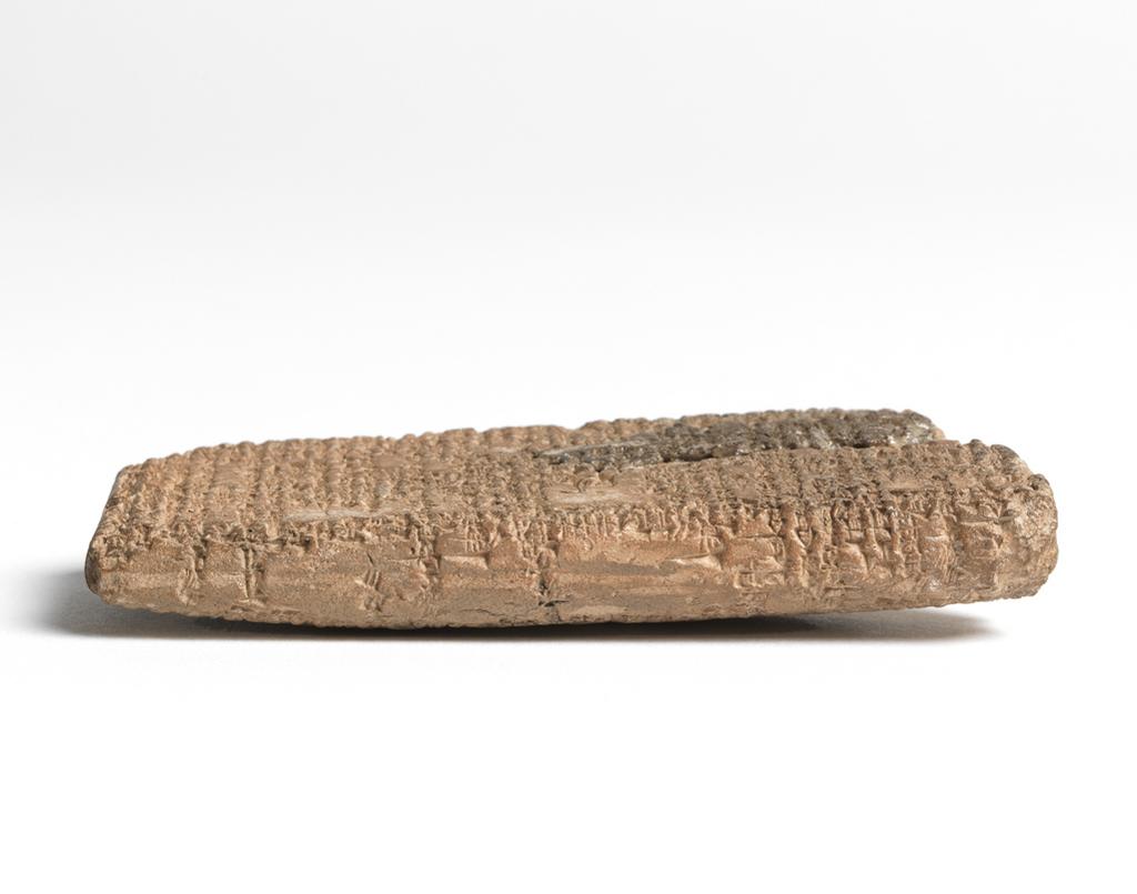 An image of Tablet, inscribed in cuneiform. Mythological list. Inscription: astrological or mythological list in Sumerian. Clay, length 0.09 m, width 0.043 m. 1st Dynasty of Babylon.
