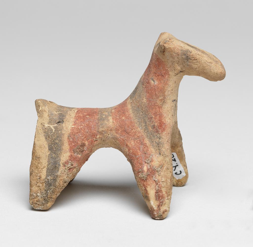 An image of Figurine. Dog. Production Place: Cyprus. Find Spot: Salamis, Cyprus. Clay, handmade, height 0.08 m, width 0.048 m, 600- 501 B.C. Archaic Period.