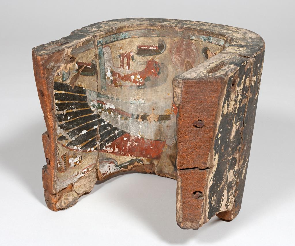 An image of Funerary Equipment/Coffin. Fragment of a painted anthropoid coffin. The inside is decorated with an image of a ba-bird and the outside is decorated with a text, which has been covered by a thick pitch-like substance. Production Place: Egypt. Painted wood, carved, height 27 cm, width 32 cm, circa 955-735 B.C. Third Intermediate period.