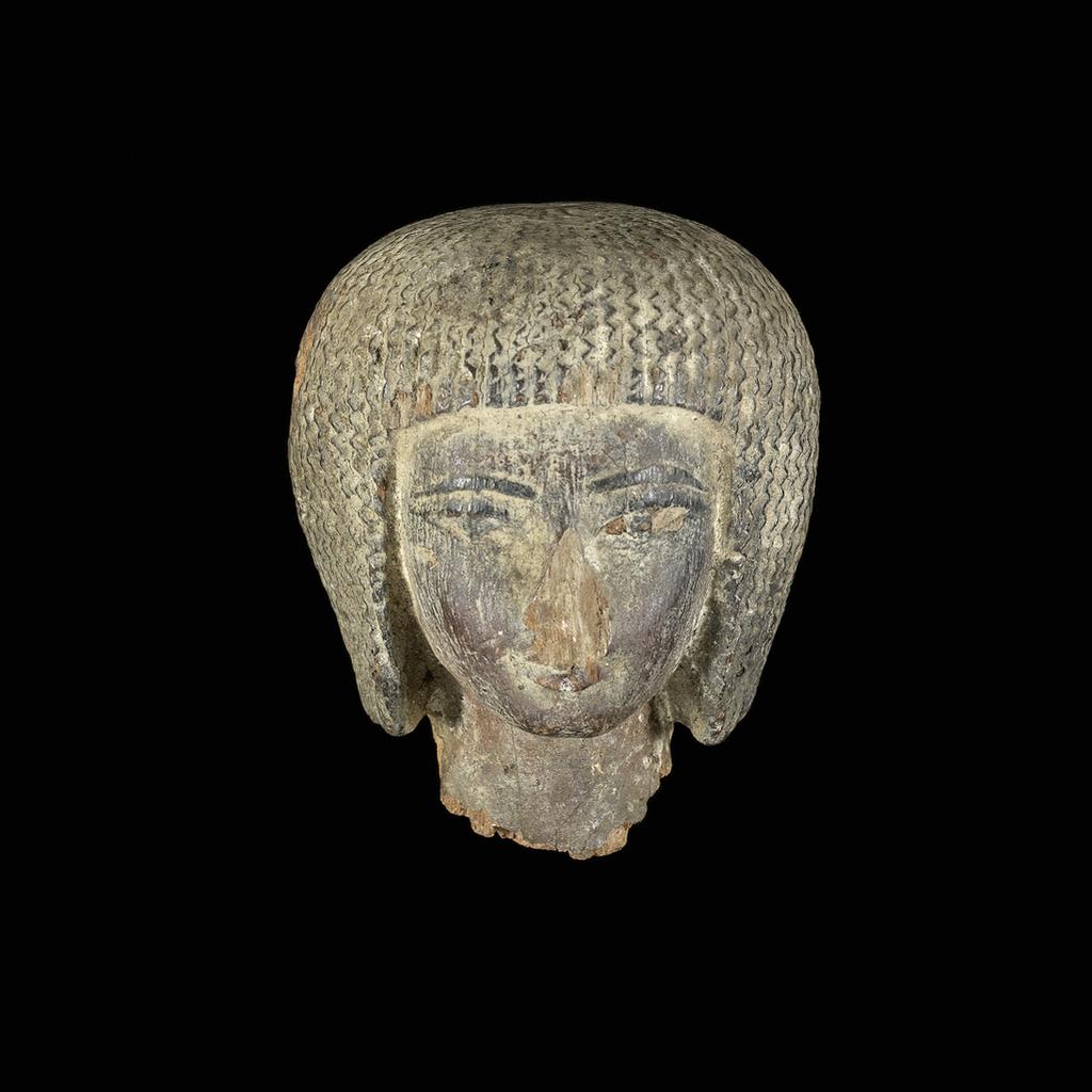 An image of Figure/statue. Female head. Production Place: Egypt. Wood, painted, depth 0.05 m, height 0.06 m, width 0.05 m.