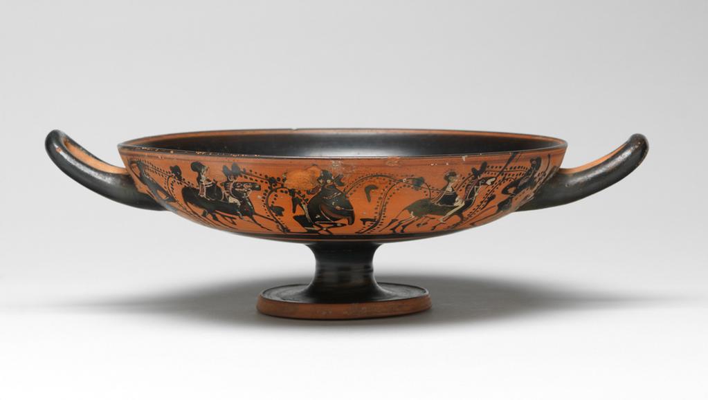 An image of Cup/Vessel. Dionysos, satyrs and donkeys, dolphin. Production Place: Athens. Clay, black-figured, height 0.083 m, width 0.273 m, diameter 0.202 m, diameter 0.068 m, 490 B.C. Archaic Period.