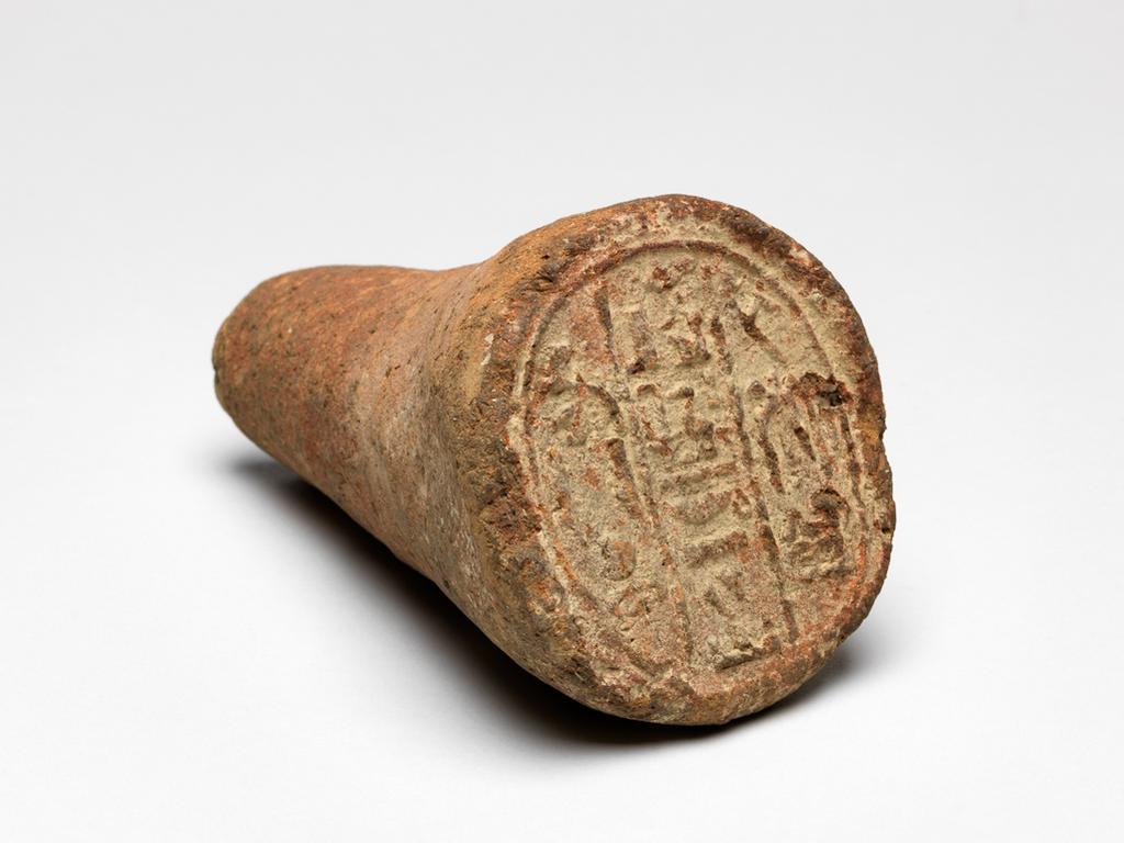 An image of Funerary cone, inscribed for the King's son of Kush, Merimose. Production Place: Egypt. Find Spot: Thebes, Egypt. Clay, remains of red haematite wash, length 11 cm, diameter 7 cm. Late Period.