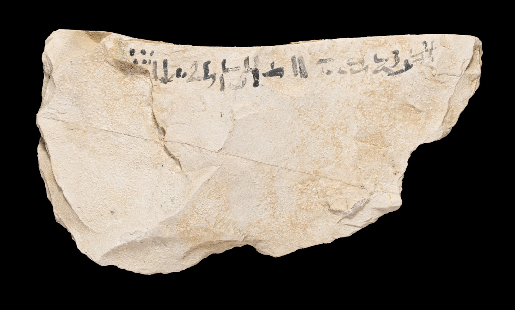 An image of Written Document. Ostracon, hieratic text, both sides, black ink. Production Place/Find Spot: Egypt. Limestone, length 0.102 m, width 0.195 m. New Kingdom.