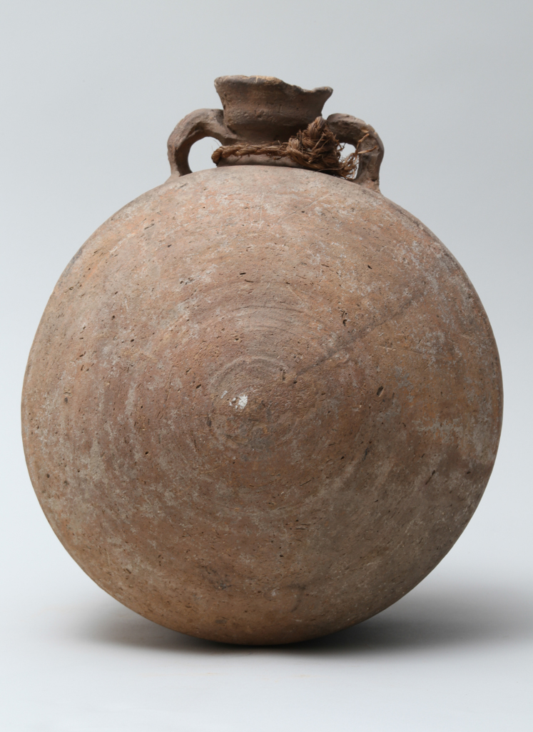 An image of Vessel. Pilgrim flask, barrel type. Production Place/Find Spot: Egypt. depth 0.255 m, diameter 0.27 m, height 0.314 m. New Kingdom.