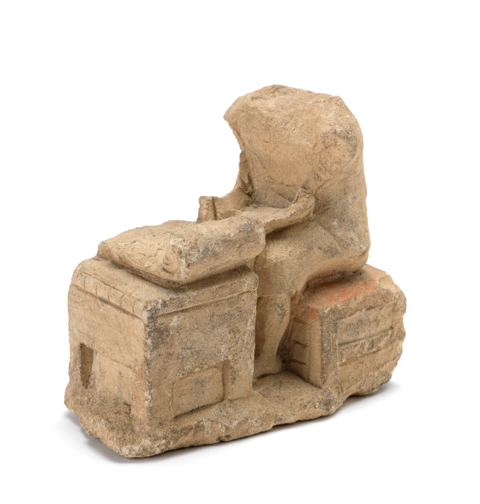 An image of Figure/statuette. Scribe. Production Place: Cyprus. Find Spot: Salamis, Cyprus; Toumpa. Limestone, depth 0.092 m, height 0.077 m, width 0.04, m, 600-501 B.C. Archaic Period.