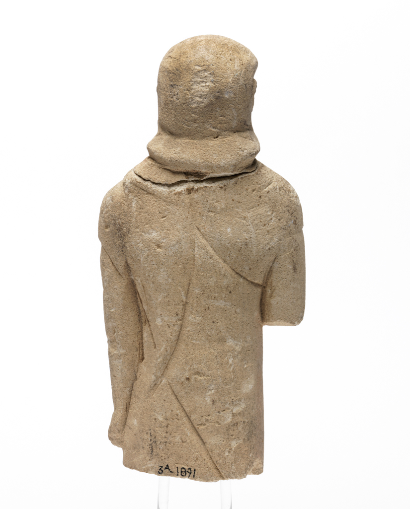 An image of Figure/Statuette. Man, standing. Production Place: Cyprus. Find Spot: Salamis, Cyprus. Limestone, depth 0.033 m, height 0.122 m, width 0.055 m, 600-501 B.C. Archaic Period.