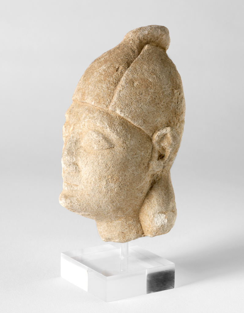 An image of Figure/Head. Man, wearing cap. Production Place: Cyprus. Find Spot: Salamis, Cyprus. Limestone, depth 0.032 m, height 0.126 m, width 0.055 m, 600-501 B.C. Archaic Period.