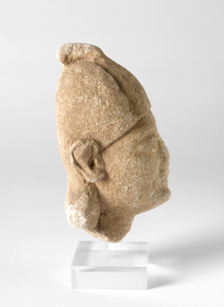 An image of Figure/Head. Man, wearing cap. Production Place: Cyprus. Find Spot: Salamis, Cyprus. Limestone, depth 0.032 m, height 0.126 m, width 0.055 m, 600-501 B.C. Archaic Period.
