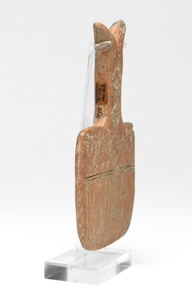 An image of Model of brush. Production Place: Cyprus. Find Spot: Vounous Cyprus; Tomb 121. Clay, red-polished ware, depth, 0.014 m, height 0.134 mwidth 0.073 m, 2200 to 2101 B.C. Early Cypriot II. Bronze Age.