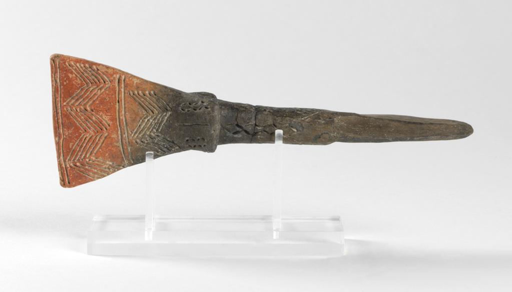 An image of Model of dagger. Production Place: Cyprus. Find Spot: Vounous Cyprus; Tomb 145. Clay, grey-black surface, height 0.183 m, depth, guards, 0.038 m, width, hilt, 0.059 m, 2200 to 2101 B.C. Early Cypriot II. Bronze Age.
