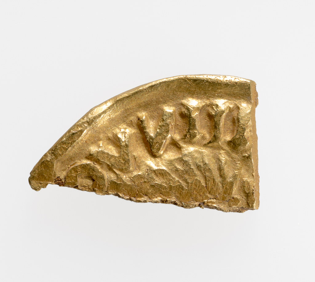 An image of Hack-gold. Louis the Pious (814-840), ruler. Viking hack-gold, cut from a Carolingian imitative gold solidus, copying Louis the Pious (814-40), probably Frisian. Gold, struck, weight 0.9 g, diameter 13.7 mm, diameter (min) 7.6 mm, mid-9th century. Medieval. Found at Torksey, Lincs., March 2010.