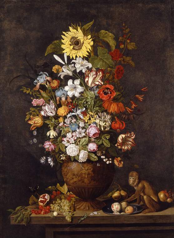 A vase of flowers with a monkey