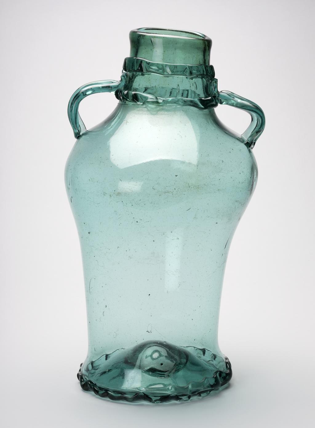 An image of Wine jar, with two handles on the neck. Unidentified German glasshouse. Bluish-green glass, height, 43 cm, diameter, 24.5 cm, 1500-1599. Sir Ivor and Lady Batchelor Bequest.