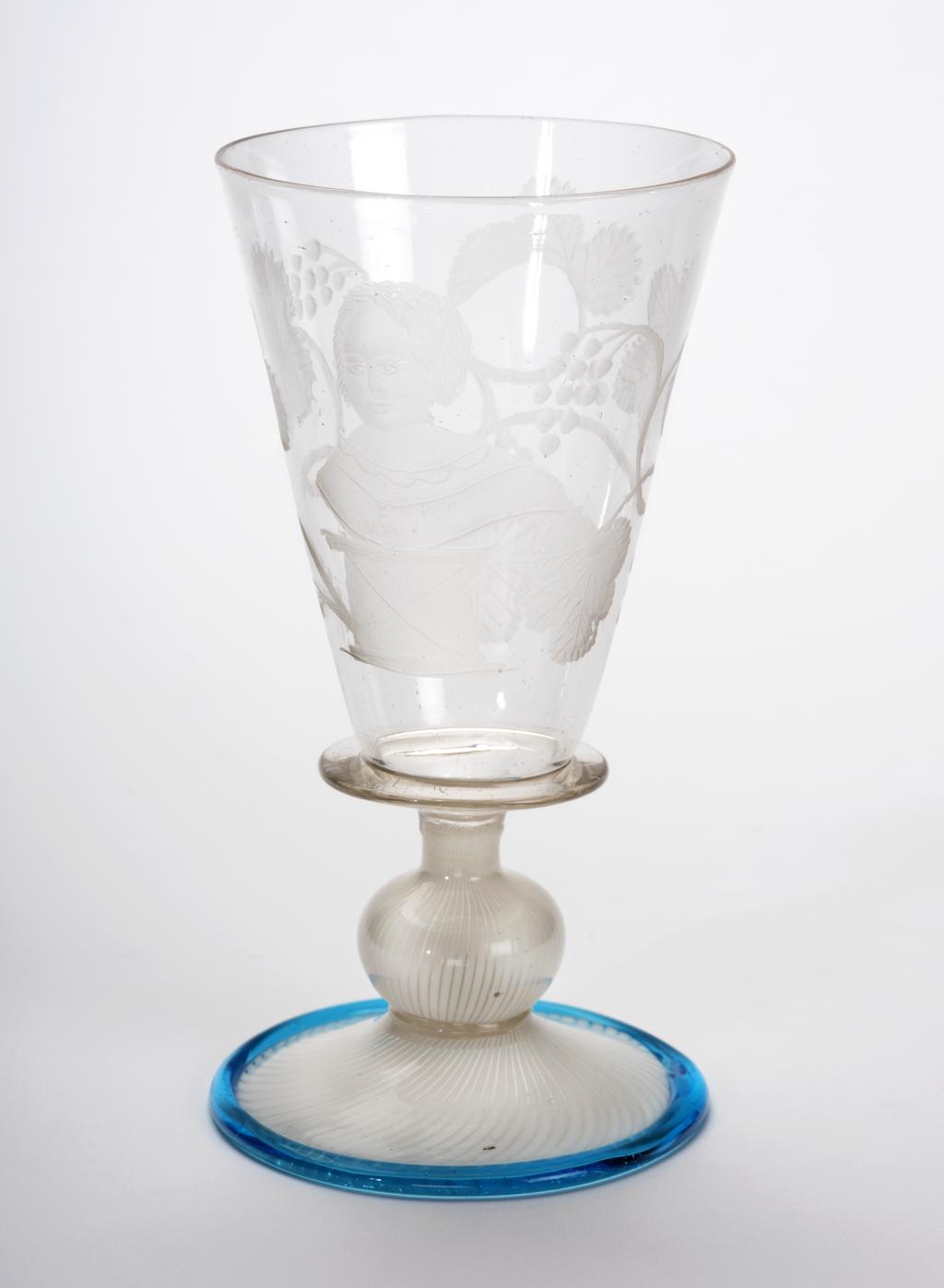An image of Wine Glass. Façon de Venise. Plain conical bowl engraved with a portrait, probably of the infant Prince Willem III of Orange (b. 1650). Soda glass, with vetro a fili foot trailed in turquoise-blue round the edge (wheel-engraving). Height, 11.3 cm, diameter, 5.7 cm, after 1655 to before 1665. Sir Ivor and Lady Batchelor Bequest through The Art Fund.