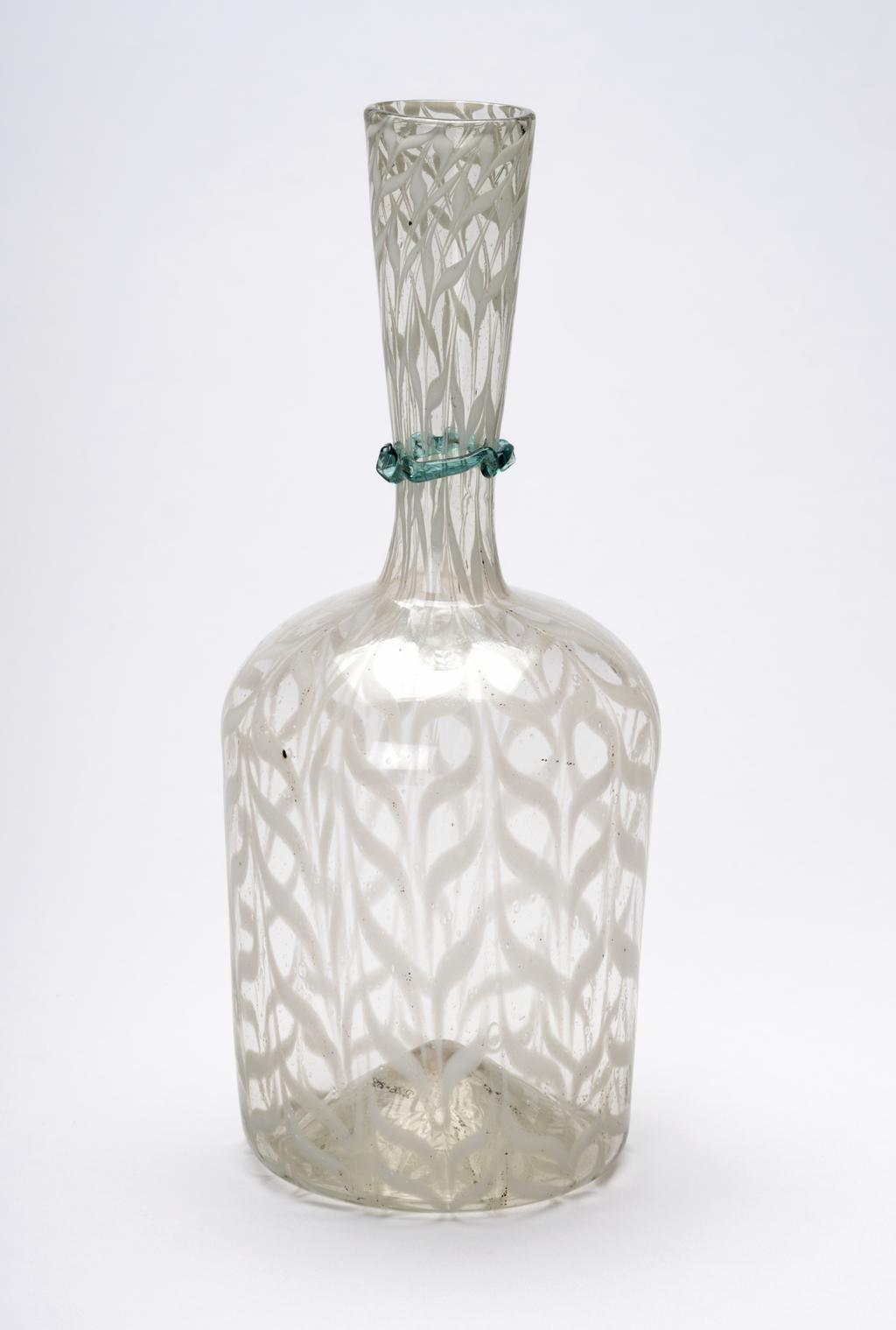 An image of Continental glass. Carafe. Façon de Venise. Unknown glasshouse, Spain, Catalonia, Barcelona. Clear greenish glass carafe or bottle, with white combed trailing, and dark turquoise undulating cord round the neck. Clear glass with combing, height, 21.7 cm, width, 8.8 cm, after 1550 to before 1650. Sir Ivor and Lady Batchelor Bequest.