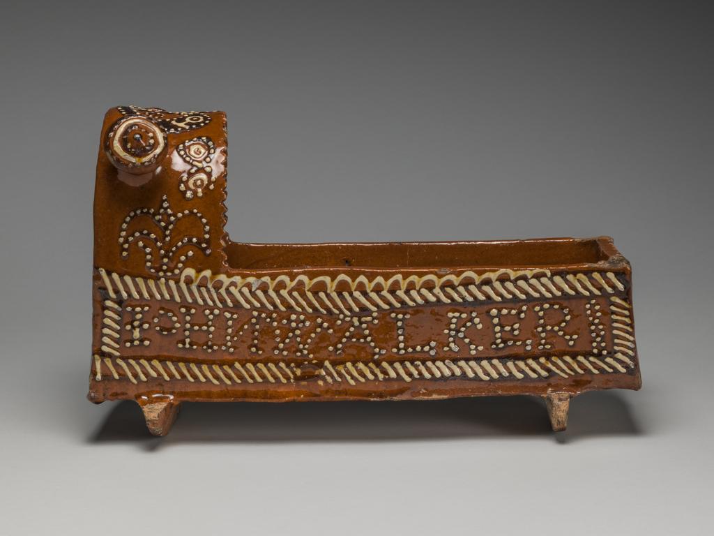 An image of Model Cradle/Commemorative Crib. Inscribed, 'JOHN WALKER, 1708'. Staffordshire pottery. Lead-glazed earthenware, slipware. English.