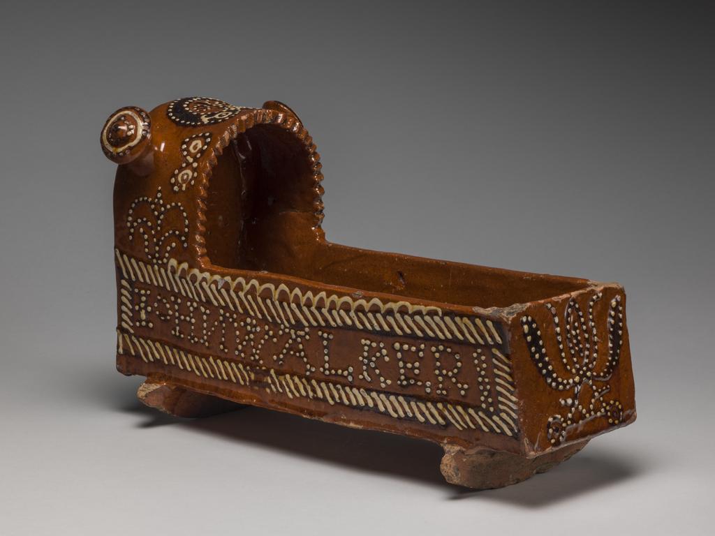 An image of Model Cradle/Commemorative Crib. Inscribed, 'JOHN WALKER, 1708'. Staffordshire pottery. Lead-glazed earthenware, slipware. English.