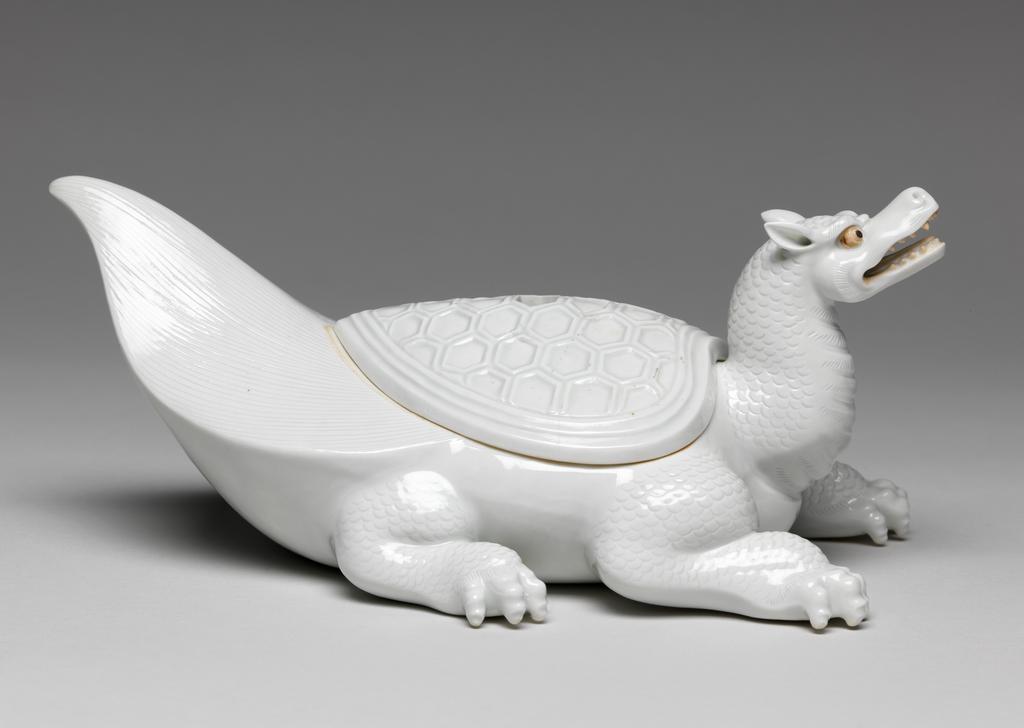 An image of Flaming tortoise, white Hirado. An immortal is missing from the lid. Unknown maker. Hard-paste porcelain, 1750-1780. Edo Period (1615-1868). Acquisition Credit: Given by David Hyatt King, through The Art Fund.