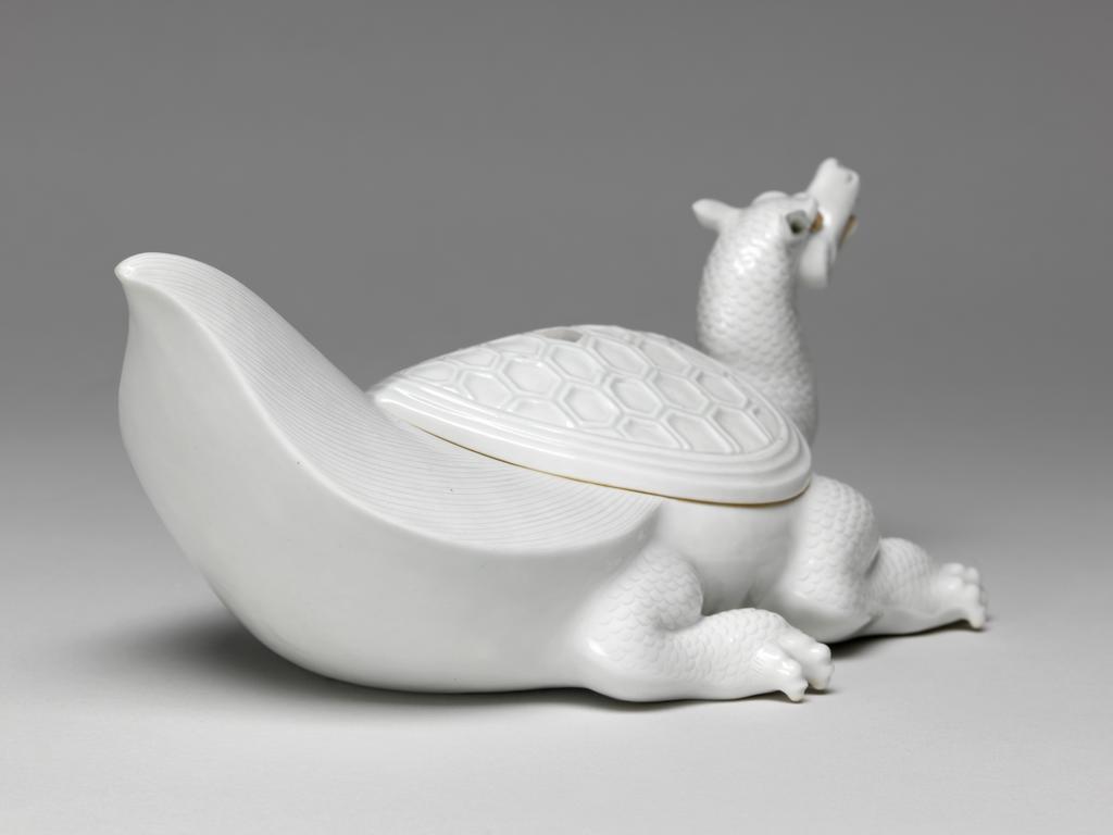 An image of Flaming tortoise, white Hirado. An immortal is missing from the lid. Unknown maker. Hard-paste porcelain, 1750-1780. Edo Period (1615-1868). Acquisition Credit: Given by David Hyatt King, through The Art Fund.