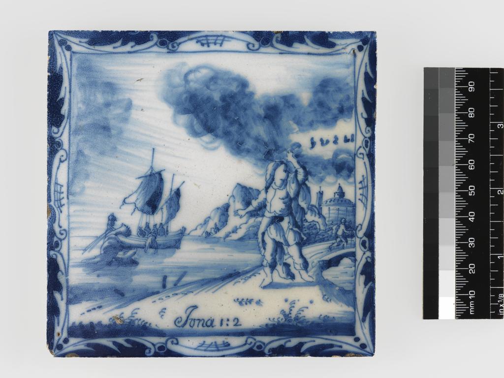 An image of Tile. Jonah Arising to go to Nineveh. Production Place: The Netherlands. In a square, framed by a scrolled border, 'Jonah Arising to go to Nineveh'. Inscribed below, 'Iona 1:2'. There is a hole in the top right and in the lower left corner. Earthenware, tin-glazed white on the upper surface and painted in blue, height, whole, 12.4 cm, width, whole, 12.5 cm, depth, whole, 0.7 cm, circa 1700-1800.