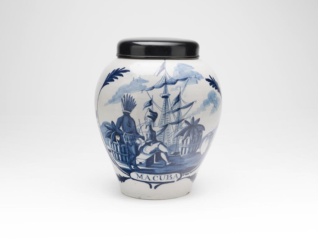 An image of Tobacco Jar painted in blue with a quay scene and labelled 'MACUBA'. The Three Bells Factory, United Provinces of the Netherlands, Delft. Buff earthenware, thrown, tin-glazed, and painted in blue. Height, whole, 25 cm, diameter, whole, 21.6 cm, diameter, cover, 13.3 cm, circa 1750 to 1820.