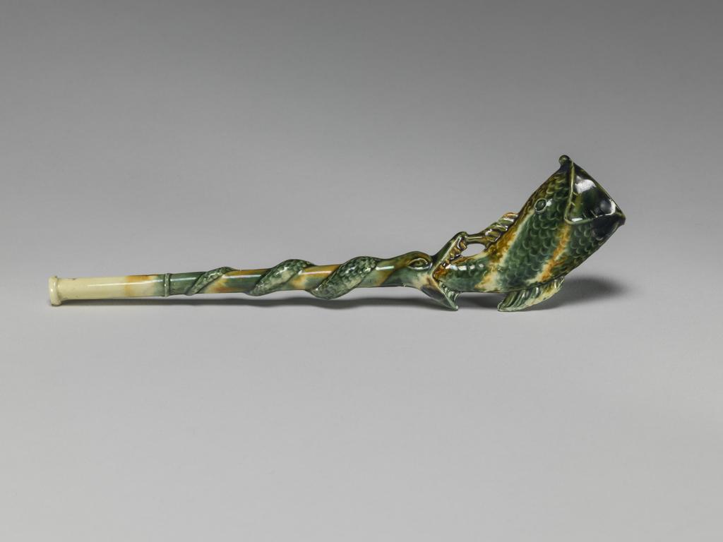An image of Pipe in the form of a fish. Unknown pottery, Staffordshire. Cream-coloured earthenware, moulded, and decorated with green, yellow, and yellowish-brown lead-glazes and metallic oxides, circa 1755-1770. Rococo.