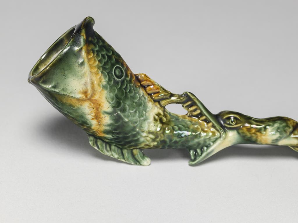 An image of Pipe in the form of a fish. Unknown pottery, Staffordshire. Cream-coloured earthenware, moulded, and decorated with green, yellow, and yellowish-brown lead-glazes and metallic oxides, circa 1755-1770. Rococo.