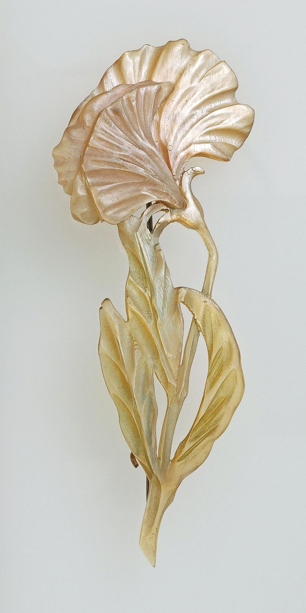 An image of Jewellery. Brooch. Pierre, Georges, Paris, Colmar. A flower on a stem with three leaves. Signed 'GIP; on the back of the flower. Gilt-metal pin fastener on the back. Horn, carved and stained pink and green, height, whole, 9.5 cm, width, whole, 3.9 cm, circa 1900-1910. Art Nouveau. Acquisition Credit: Given by Mrs J. Hull Grundy.