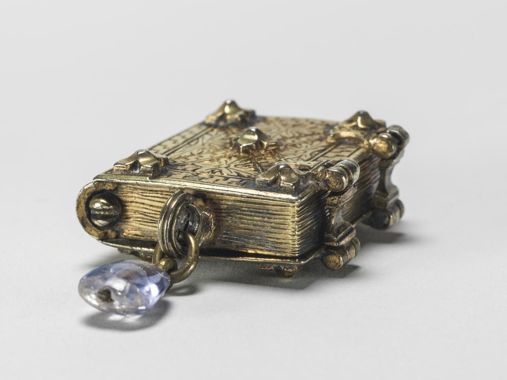 An image of Pendant Book. Jewellery/Pendant. Silver-gilt, with leaves made of silver and engraved with scenes from the Passion. Perhaps for attaching to a rosary, with pendant amethyst. Scenes: Annunciation, Nativity, Last Supper, Agony in the Garden, Kiss of Judas, Christ before Pilate, Scourying of Christ, The Mocking of Christ, Christ Carrying the Cross, the Erection of the Cross, Christ being Nailed to the Cross, the Crucifixion Deposition, Entombment, Resurrection, Christ Child Enthroned, a Pope and a female Saint. Silver-gilt, height, whole, 6.0 cm, width, whole, 2.8 cm, circa 1500- circa 1700. German.