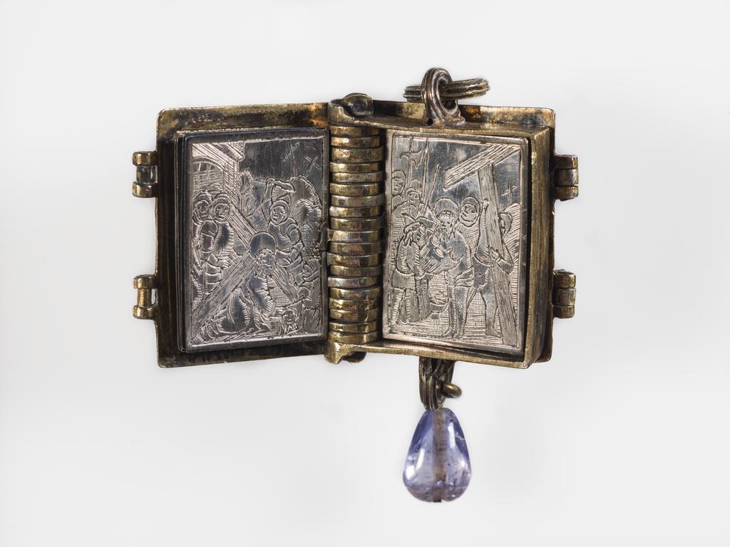 An image of Pendant Book. Jewellery/Pendant. Silver-gilt, with leaves made of silver and engraved with scenes from the Passion. Perhaps for attaching to a rosary, with pendant amethyst. Scenes: Annunciation, Nativity, Last Supper, Agony in the Garden, Kiss of Judas, Christ before Pilate, Scourying of Christ, The Mocking of Christ, Christ Carrying the Cross, the Erection of the Cross, Christ being Nailed to the Cross, the Crucifixion Deposition, Entombment, Resurrection, Christ Child Enthroned, a Pope and a female Saint. Silver-gilt, height, whole, 6.0 cm, width, whole, 2.8 cm, circa 1500- circa 1700. German.