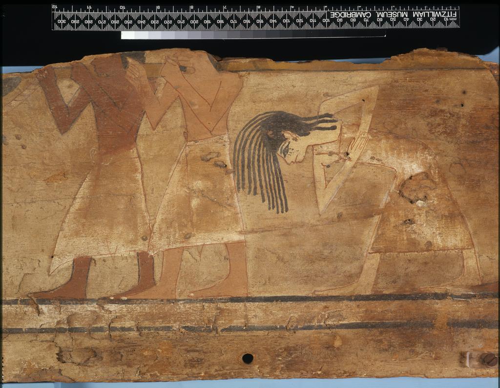 An image of Funerary Equipment. Coffin fragments, decorated. This coffin shows a procession of mourners, who consisted of friends, servants and family of the deceased. Unlike the Middle Kingdom eye coffins, where both eyes are shown on a single panel, this example only has one eye on each of the side panels. Production Place: Egypt, Find Spot: Arabah, el- Egypt. Wood, painted, height 39.3 cm, length 111.6 cm, 1580-1550 B.C. Previously attributed to Dynasty 13. Seventeenth Dynasty. Middle Kingdom.