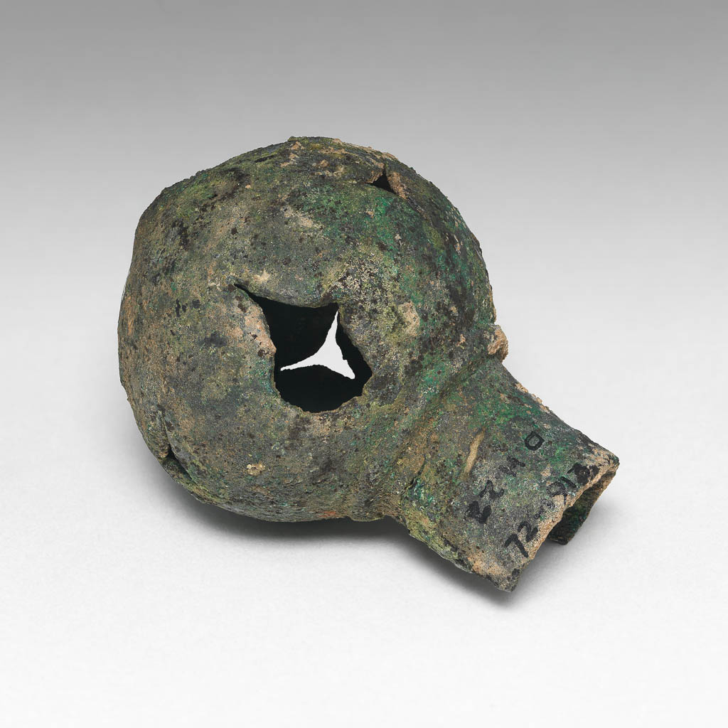 An image of Equipment. Finial. Spear butt or terminal, spherical with cut-out decoration. Production Place: Syria. Find Spot: Deve Hüyük, Syria. Copper alloy, height 6.3 cm, diameter 1.89 cm, diameter 4.57 cm.