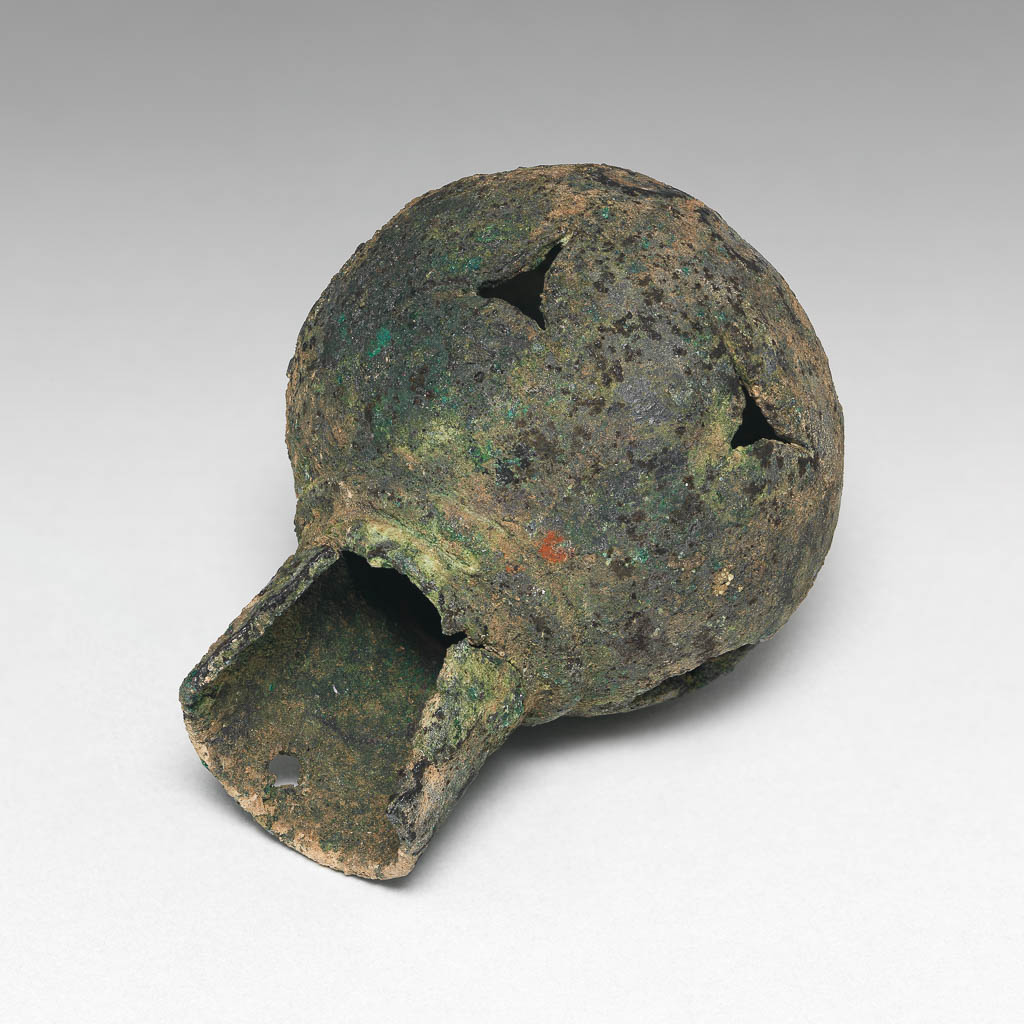 An image of Equipment. Finial. Spear butt or terminal, spherical with cut-out decoration. Production Place: Syria. Find Spot: Deve Hüyük, Syria. Copper alloy, height 6.3 cm, diameter 1.89 cm, diameter 4.57 cm.