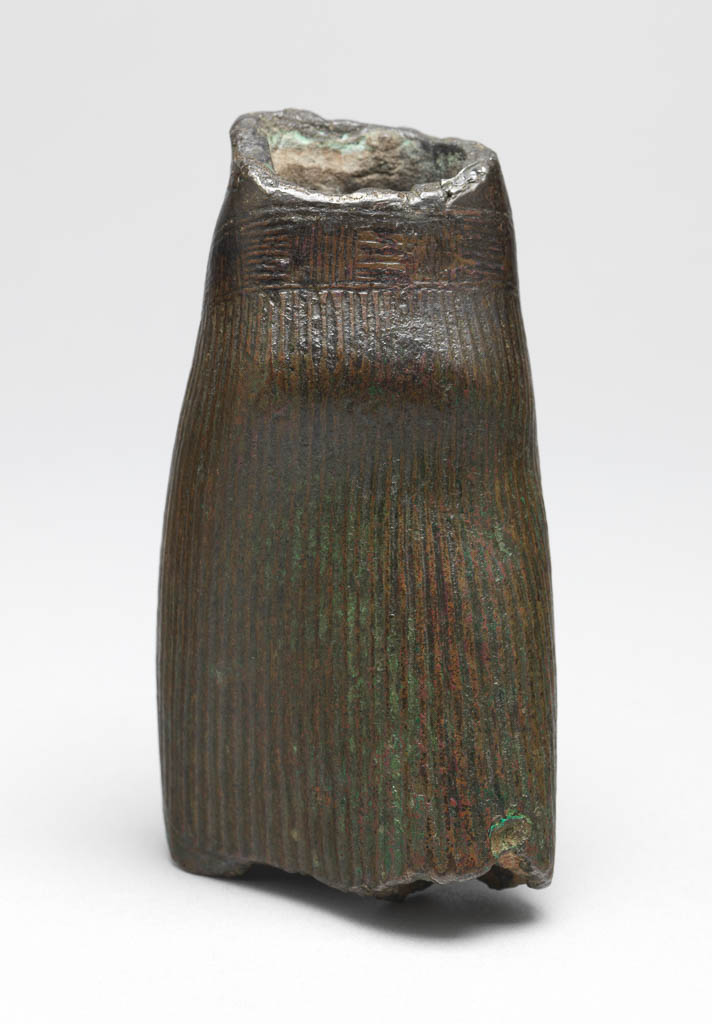 An image of Torso of a king with pleated skirt. Inscription: cartouche of Ramesses V. Production Place: Egypt. Bronze, hollow cast, height 11 cm, 1156-1151 B.C. Twentieth Dynasty. New Kingdom.