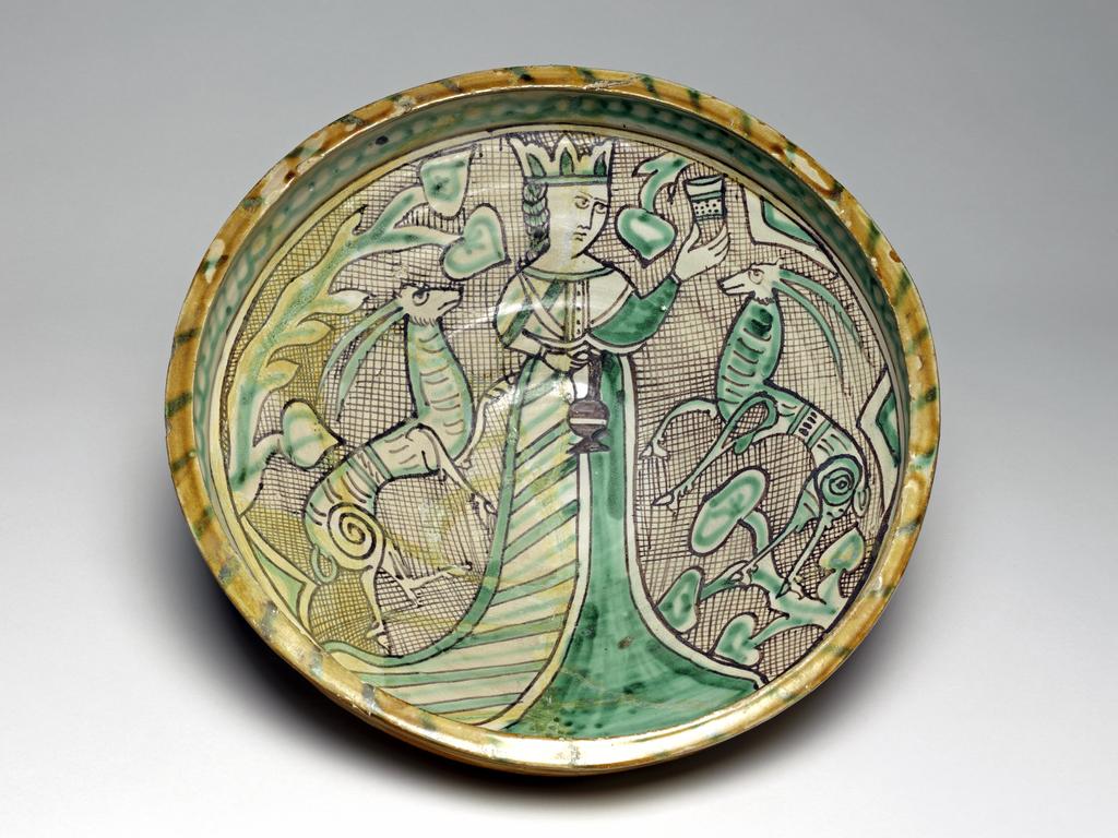 An image of Unknown (pottery). Maiolica arcaica. Pale buff earthenware, the interior tin-glazed, the exterior and top of the rim lead-glazed, height 11.2cm, diameter, rim, 31.5cm, diameter, foot, 14.2cm, circa 1275-1350. Italian, from Orvieto.