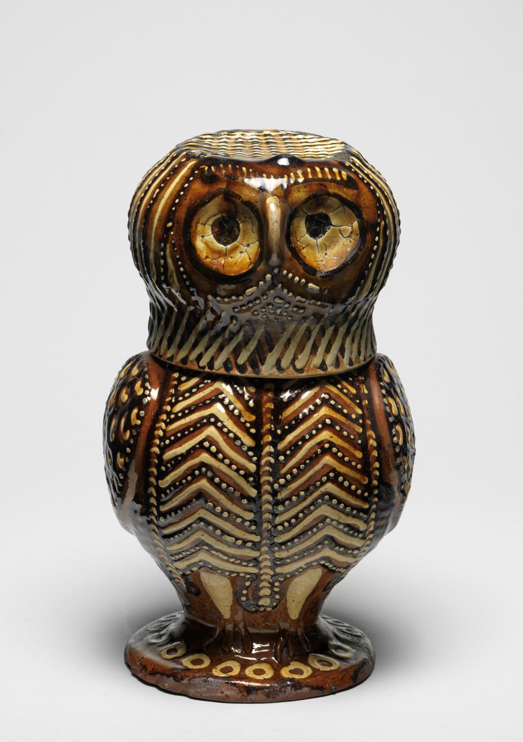 An image of Owl Jug. Lead-glazed earthenware, thrown in two parts, decorated with slip-trailing in two shades of brown and white slip, height 22.4 cm, circa 1680-1700. Staffordshire, England.